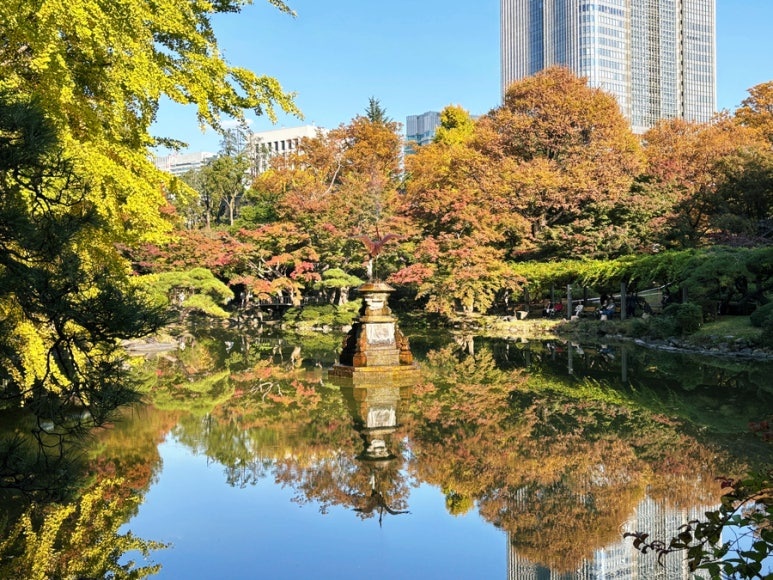 Lush autumn foliage and walking paths at Hibiya Park during daytime visit