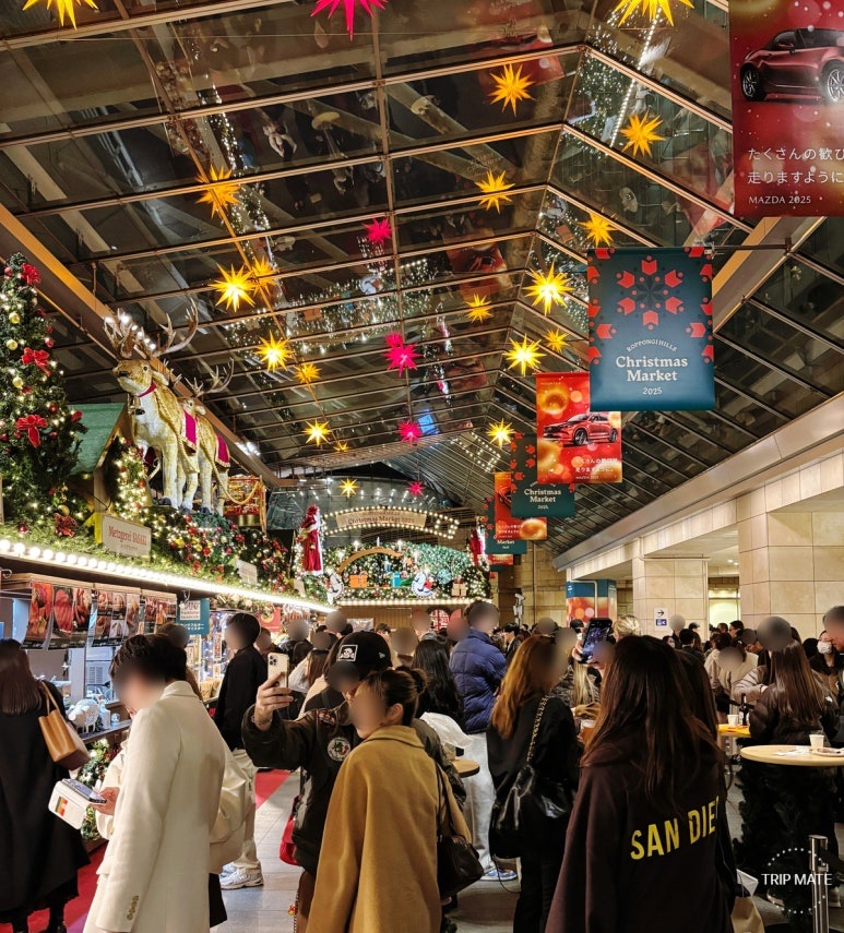 Roppongi Hills Christmas Market food area with people enjoying Glühwein and German sausages