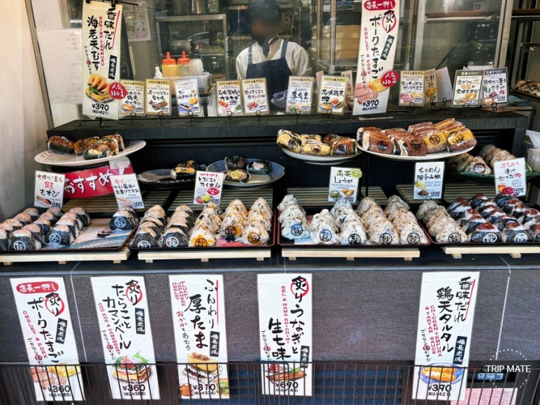 Various handmade onigiri displayed at Shinjuku Onimaru
