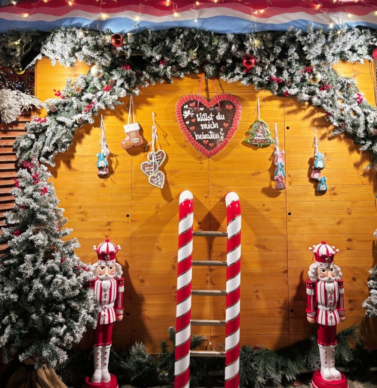 Christmas market hut displaying traditional German Erzgebirge wooden figurines and ornaments