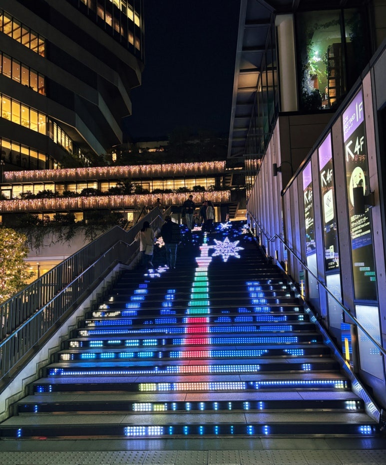 Outdoor escalator leading to 4th floor market with Skytree tower backdrop